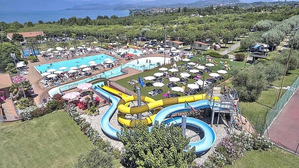 A water park with multiple pools, slides, and sunbathing areas. - Apartment Rosa Portland With Pool (Lazise)