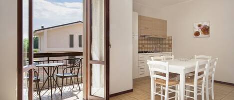 A modern kitchen with white cabinets and a tiled backsplash.