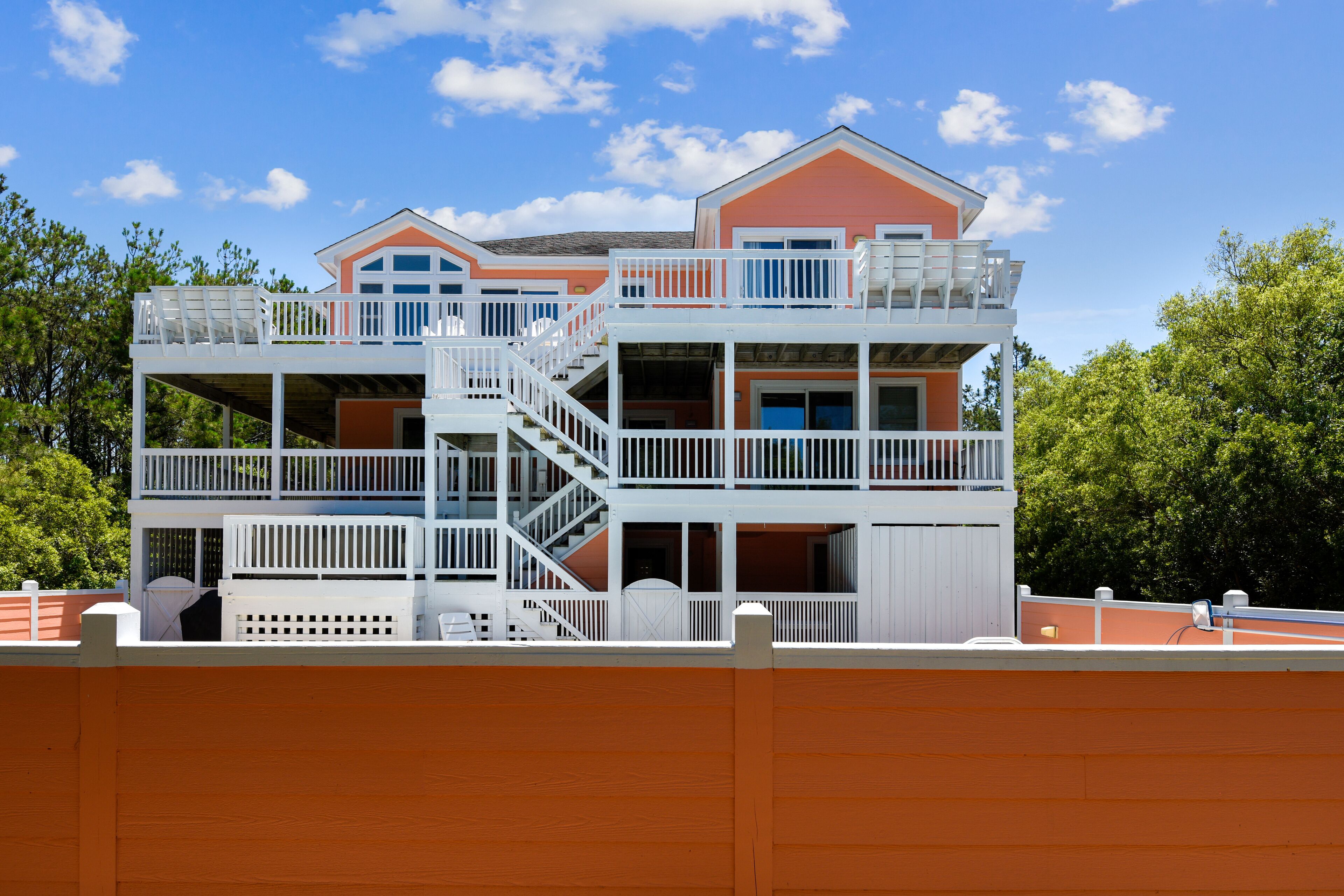A multi-story building with balconies and a staircase.