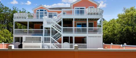 A multi-story building with balconies and a staircase.