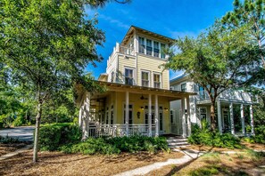A two-story house with a porch, columns, and a garage. - WaterColor Beach Home w/ Resort Amenity Passes, Sleeps 8 + Free Tickets! (Santa Rosa Beach)
