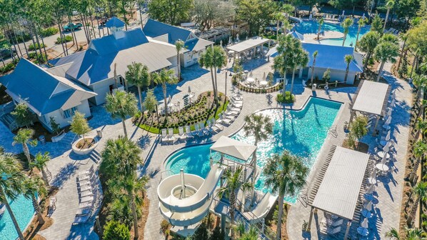 Un complexe hôtelier doté de plusieurs piscines, de palmiers et d’espaces de détente.