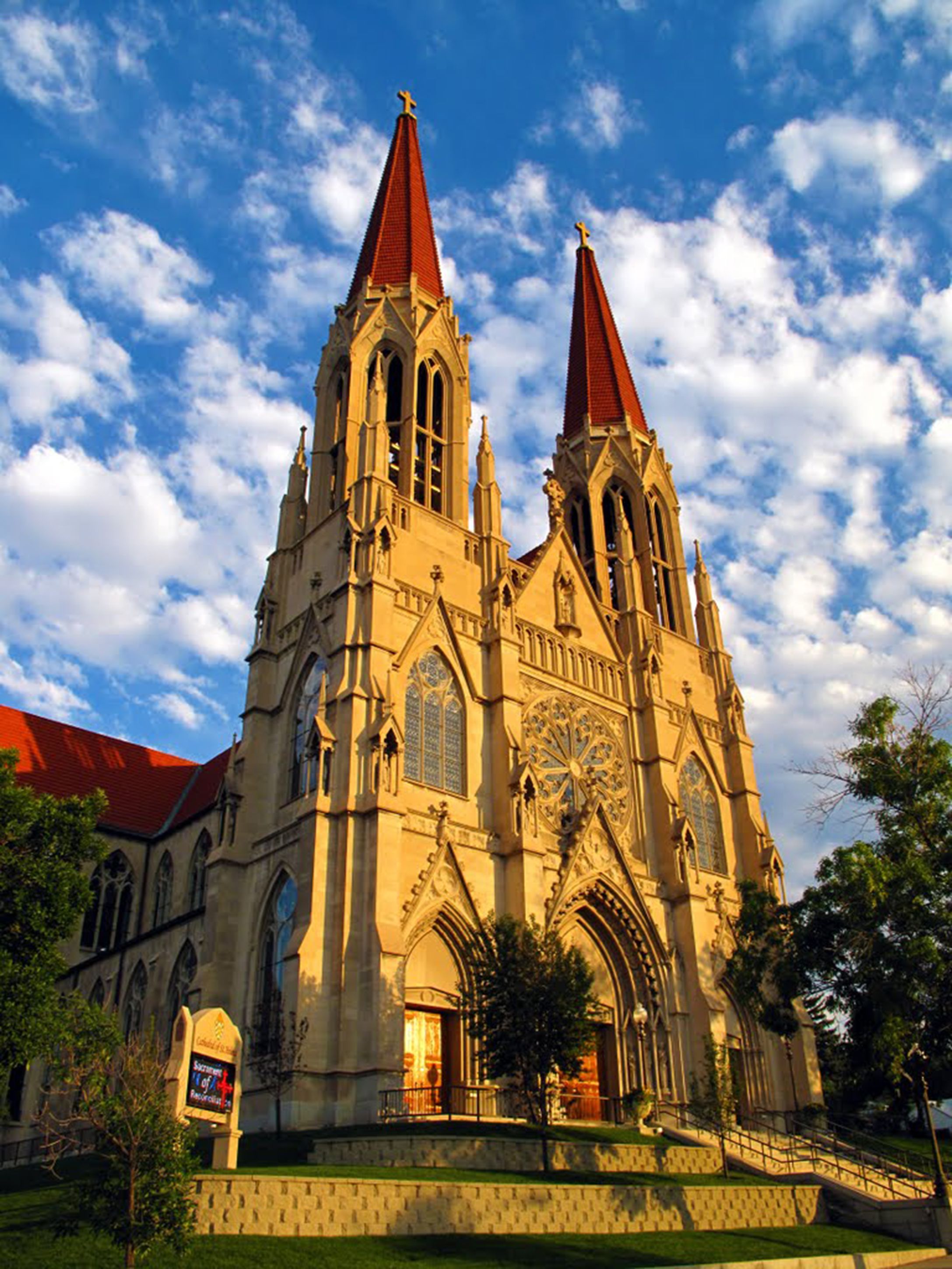 A large Gothic-style church with two tall spires and a clock tower.