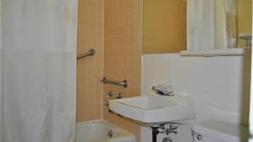 A bathroom with a bathtub, a sink, and a toilet.