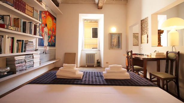 A room with a bed, a bookshelf, a radiator, a desk, and a chair. - The Trevi Fountain and Spanish Steps Experience (Roma)