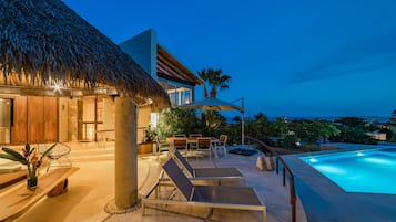 An infinity pool, pool loungers