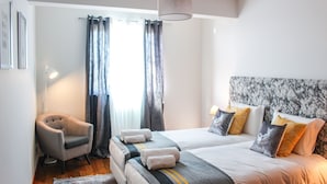 A hotel room with a bed, a chair, and a desk. - The Seaside Apartment by LovelyStay (Funchal)