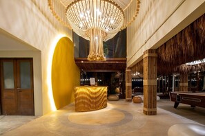 A lobby with a reception desk, a large chandelier, and a pool table. - Tamarina Bed and Beyond (Koh Samui)