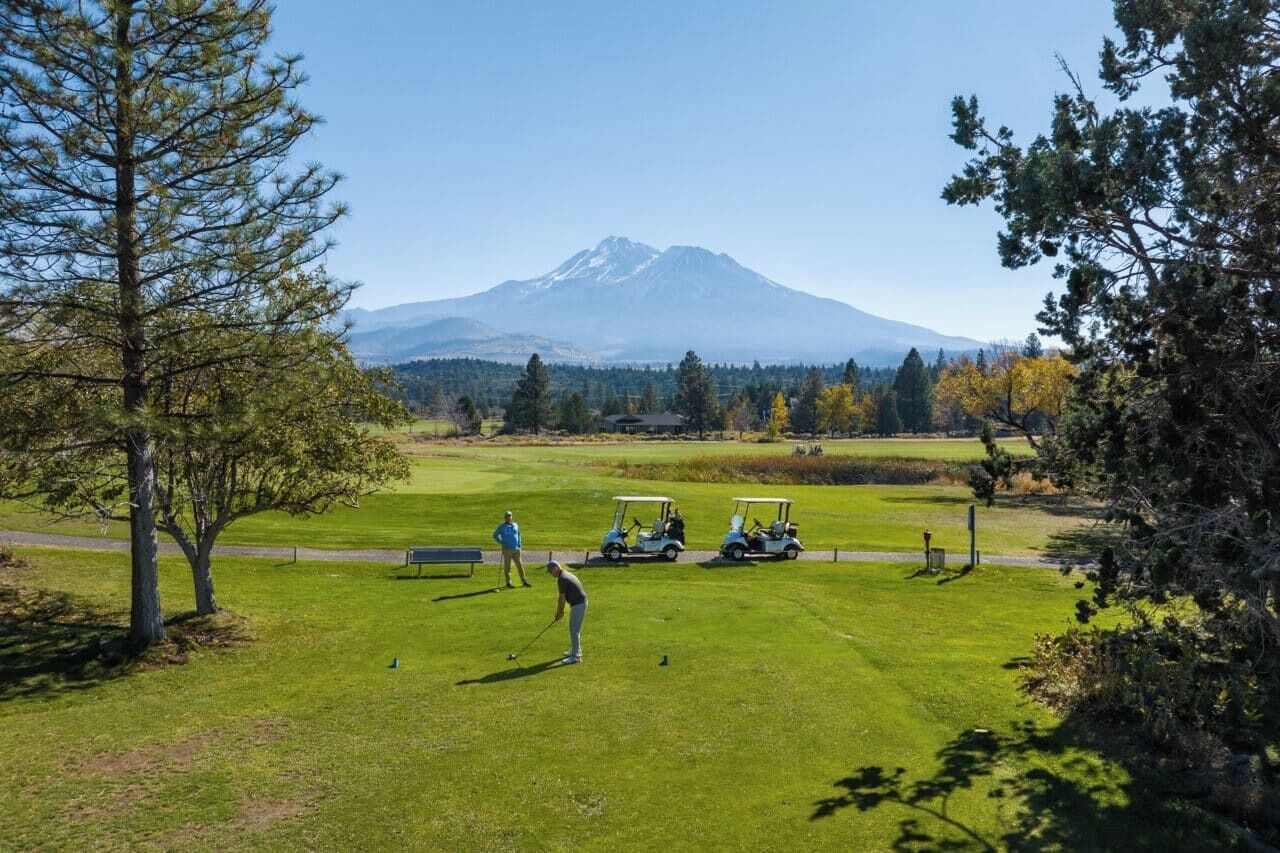 A golf course with a mountain in the background.