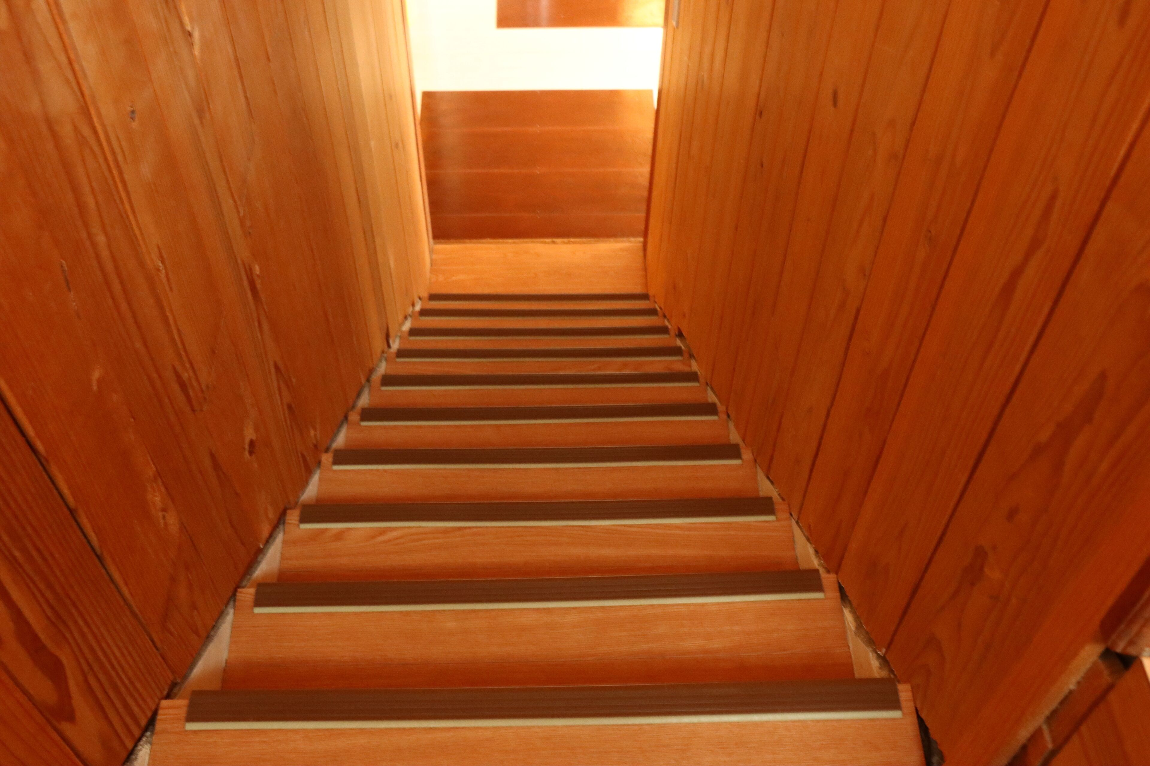 A wooden staircase with a straight path leading upwards.