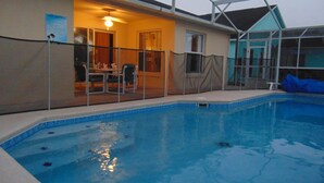 An indoor swimming pool with a covered patio area. - Cozy/Spacious House with Private Pool and Lake View (Davenport)