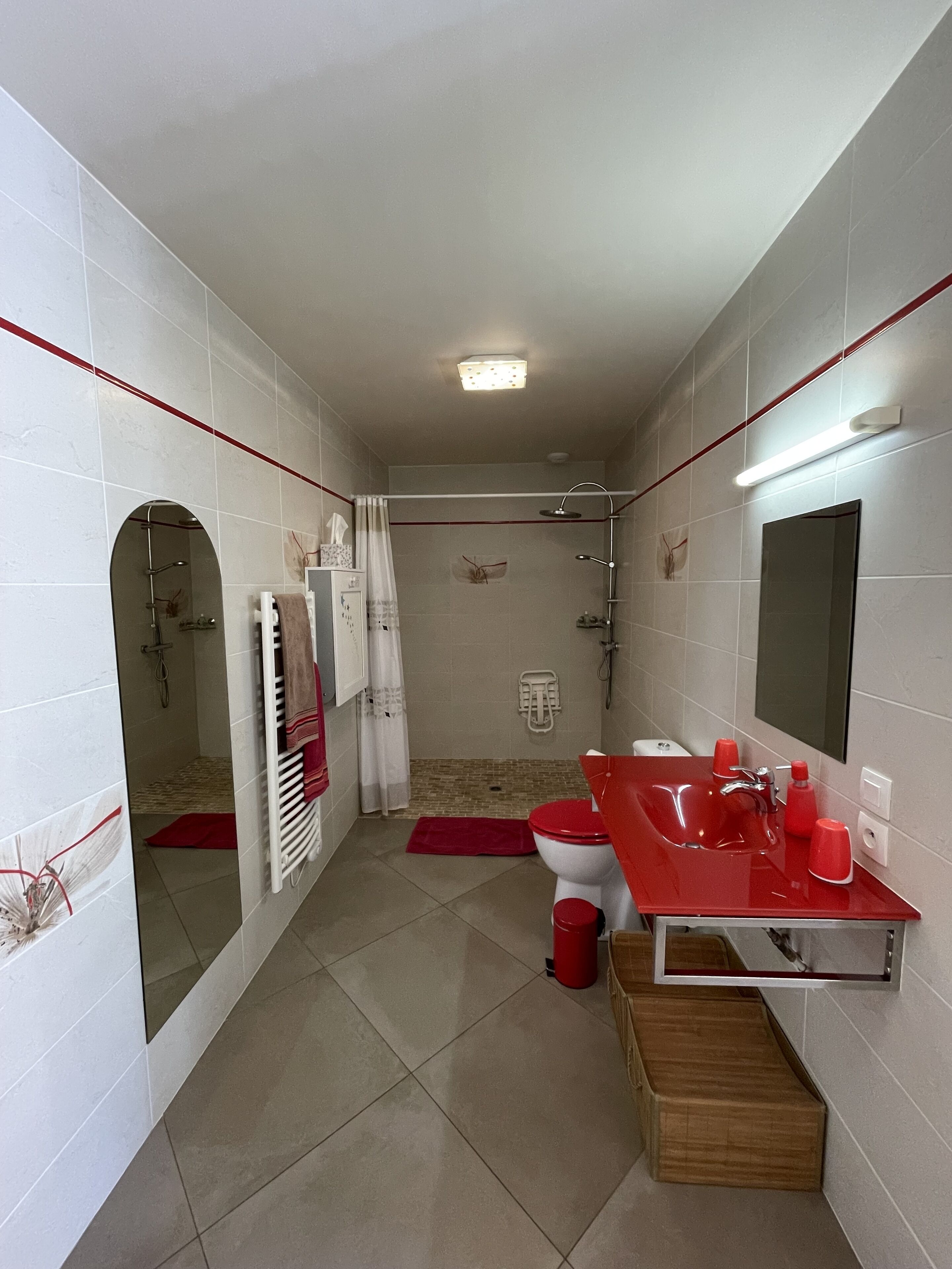 A bathroom with a shower, toilet, and sink.