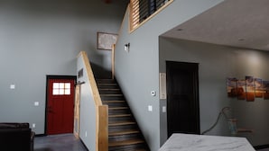 A staircase with wooden steps and a red door at the bottom. - Home away from Home , just minutes from Deadwood. (Deadwood)