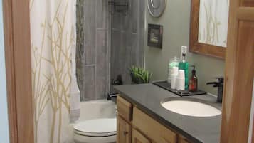 Combined shower/tub, hair dryer, towels, soap