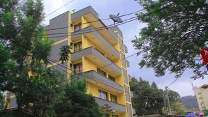 A multi-story building with balconies, a satellite dish, and a red traffic sign. - Yonas Hotel (Addis Ababa)