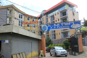 A multi-story building with a sign for "FUNZONE" and "A.S Pension".