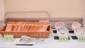 A breakfast buffet setup with bread, bowls, and utensils. - Cai-Lai Hotel (Taoyuan City)