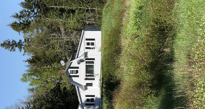 Rustic vintage cottage in Duck Cove with limited ocean view.