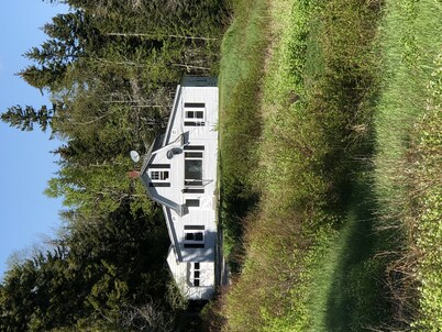 Rustic vintage cottage in Duck Cove with limited ocean view.