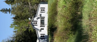 Rustic vintage cottage in Duck Cove with limited ocean view.