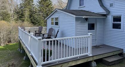 Rustic vintage cottage in Duck Cove with limited ocean view.