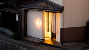 A traditional Japanese house with a tiled roof, wooden exterior, and a small porch area. - Higashiyama Aritsuki (Kanazawa)