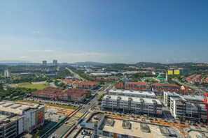 A cityscape with a mix of modern and traditional buildings, a clear sky, and a distant mountain range. - Comfort Zone Premium Guesthouse Evo1 (Bandar Baru Bangi)