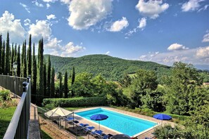 A swimming pool with a view of a mountainous landscape.