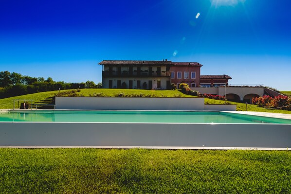 Outdoor pool, open 8 AM to 9 PM, pool umbrellas, pool loungers