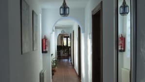 A hallway with tiled flooring, white walls, and a ceiling light fixture. - Casa Rural Mi Abuela María - Adults Only (Mojacar)