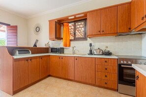Villa | Private kitchen | Full-size fridge, microwave, oven, stovetop