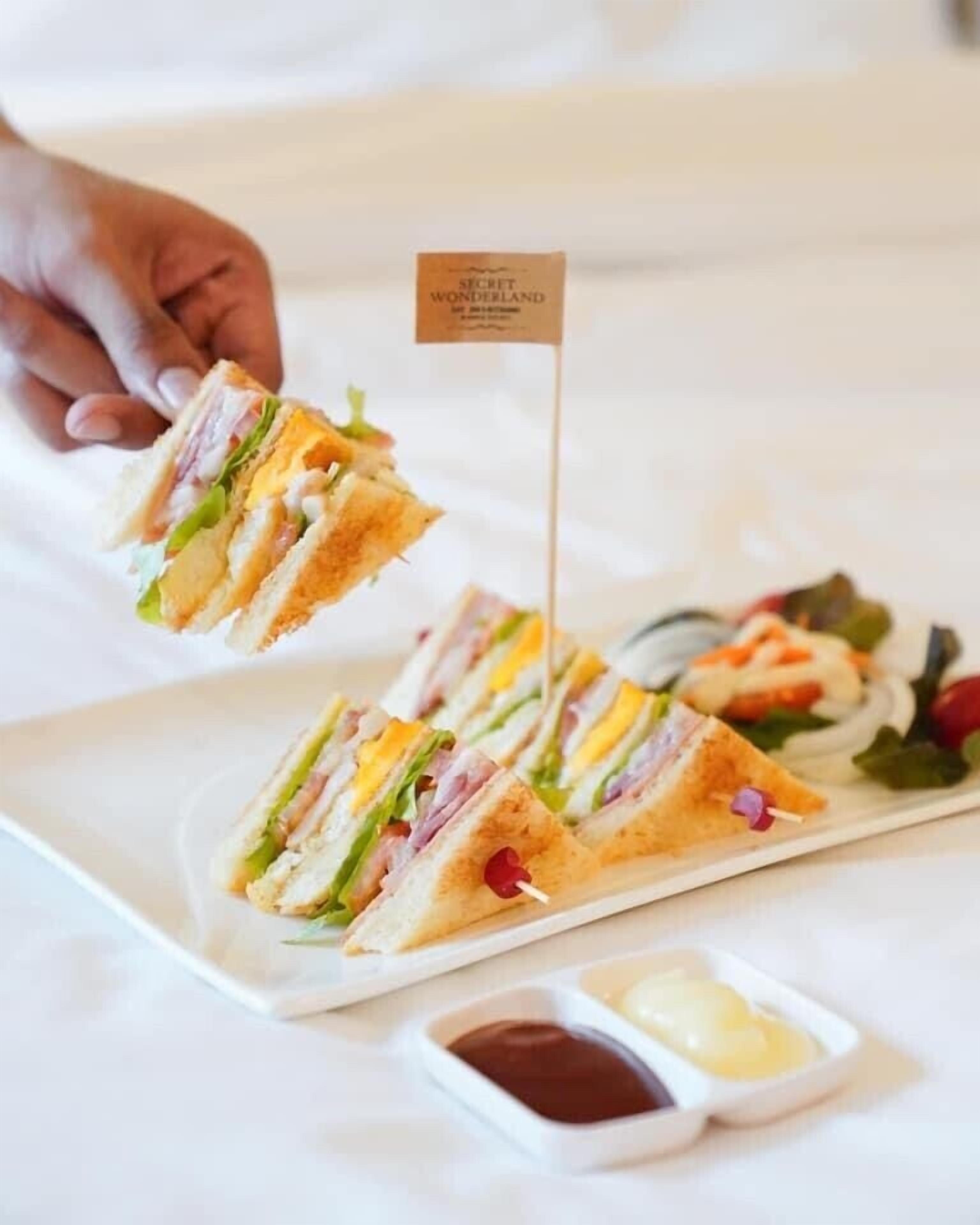 A sandwich with a flag on a plate.