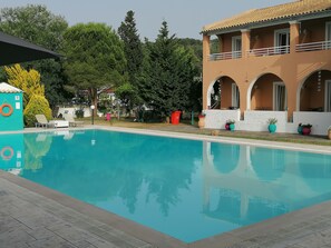 Outdoor pool, pool umbrellas, sun loungers