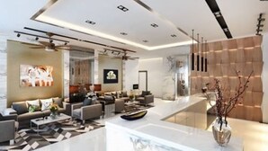 A modern living room with a central seating area, a large window, and a decorative vase. - ibiz Boutique Hotel (Nakhon Si Thammarat)
