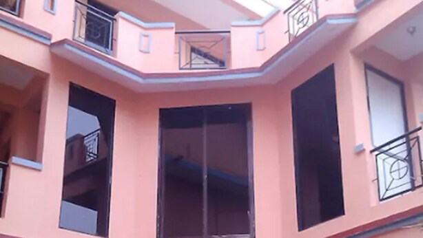 A multi-story building with large windows and balconies. - Dev Guest House (Lalitpur)