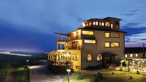 A multi-story hotel with outdoor seating and a view of the landscape. - Seven Generations Winery Hotel & SPA (Ivanovo)