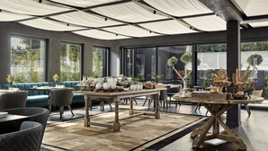 A modern dining area with a wooden table, cushioned seating, and large windows offering views of greenery. - Azur Hotel (Vari-Voula-Vouliagmeni)