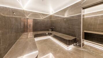 Relax in a spacious bathroom with a large bathtub and separate shower area.