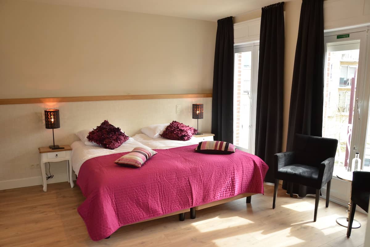 Deluxe Quadruple Room, 1 Bedroom, Balcony, Garden View | Premium bedding, minibar, in-room safe, individually furnished
