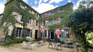 A courtyard with outdoor seating, surrounded by ivy-covered buildings.