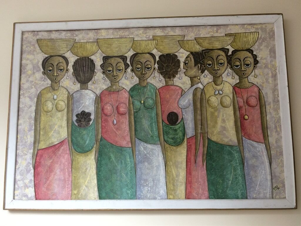 A framed artwork depicting a group of figures with baskets on their heads.