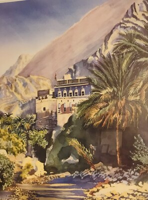 A traditional building with arched windows and a flat roof, surrounded by palm trees and mountains. - Moulin A (Saint-Etienne-de-Boulogne)