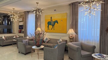 A modern living room with sofas, a coffee table, and decorative lamps.