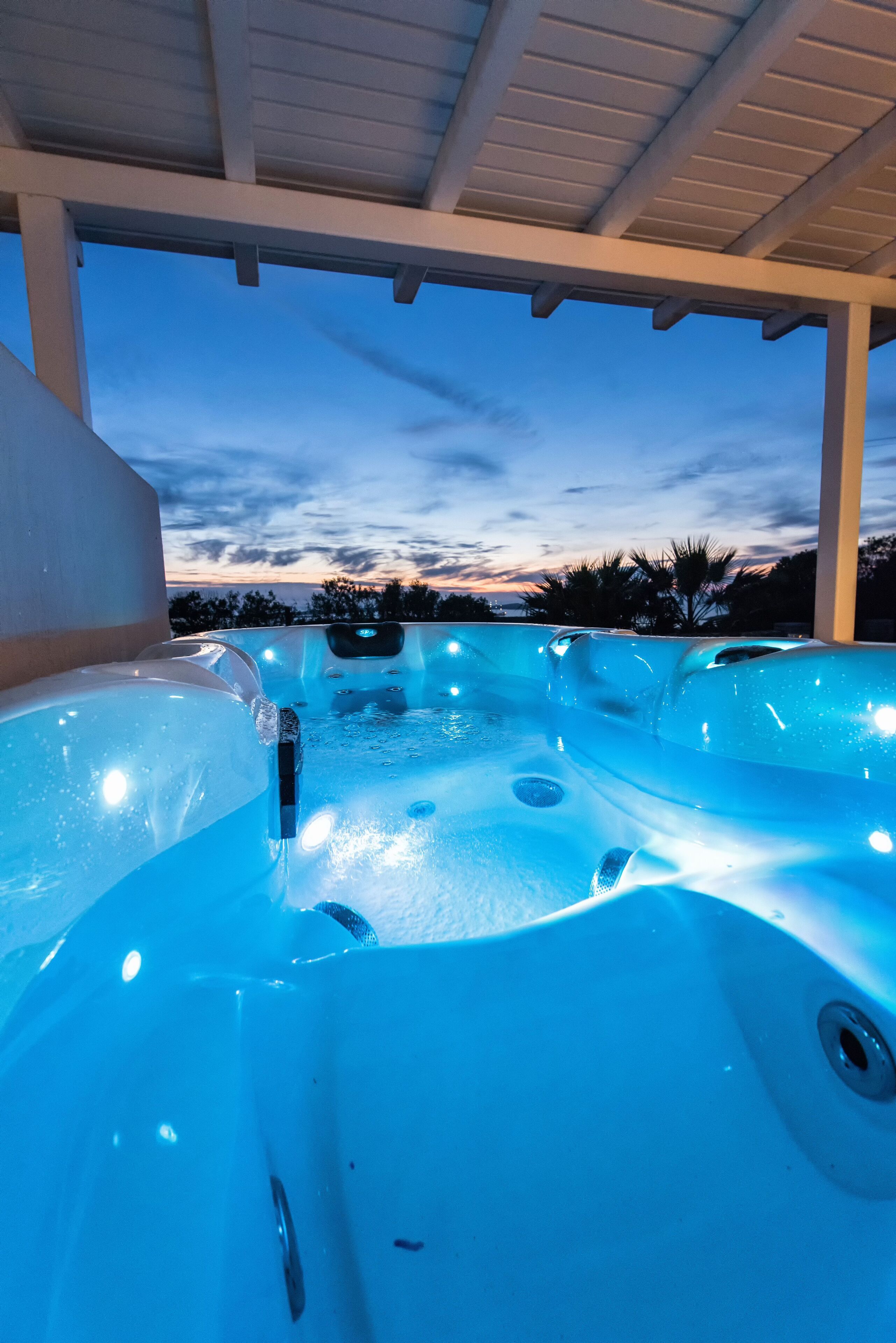 A hot tub area with a view of the sky at dusk.
