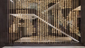A staircase with a unique rope design. - Texas A&M Hotel and Conference Center (College Station)