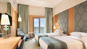 A hotel room with two beds, a desk, a chair, and a view of the outdoors. - TRYP by Wyndham Izmit (Basiskele)