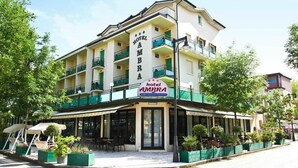 A hotel with a sign reading "Hotel Ambra" and a private parking area. - Hotel Ambra (Cesenatico)