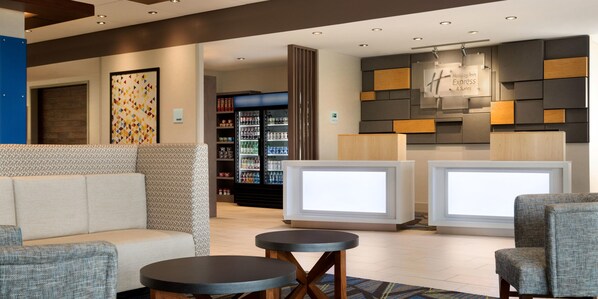 A lobby with seating, a reception desk, and a refrigerator stocked with beverages. - Holiday Inn Express Chelmsford by IHG (Chelmsford)