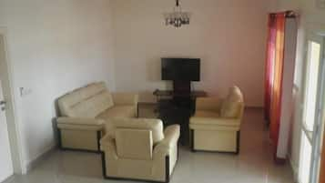 Apartment, 1 Bedroom | Living room | Flat-screen TV