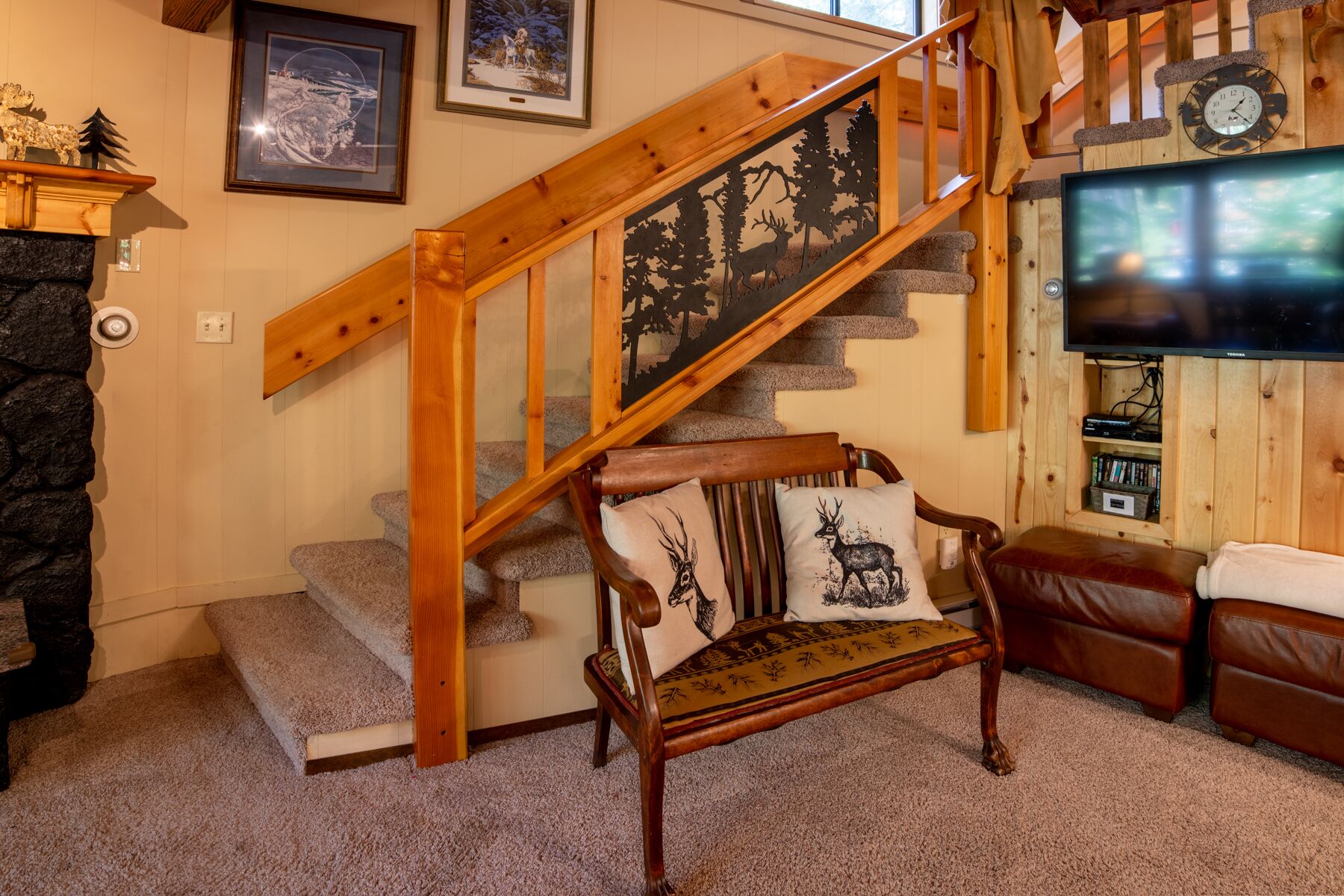 A staircase with a wooden handrail and a black silhouette cutout design.